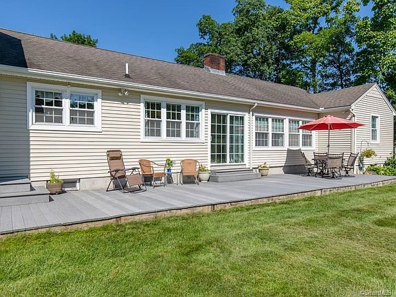 Rear exterior close-up of 609 Racebrook Rd. The deck is made with TREX and is approximately 300 sq ft and steps downs easily to the level of the yard.