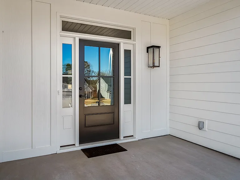 Welcoming flickering gas lamp and a beautiful door at the front entrance.
