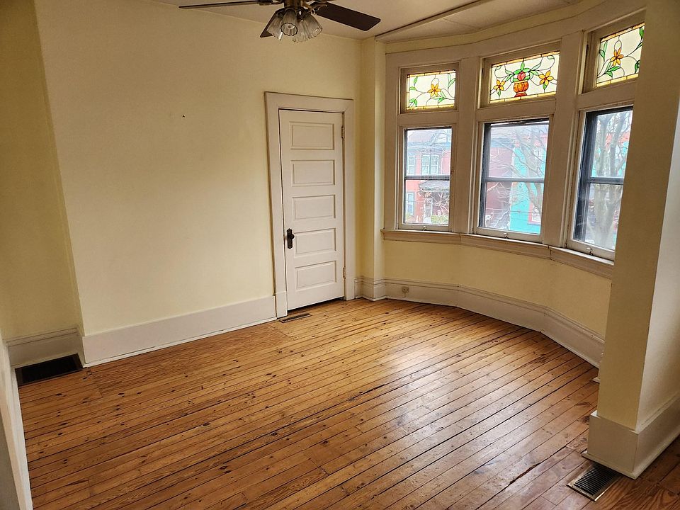 Open concept living area with stained glass accents and closet, overlooking Mifflin Ave