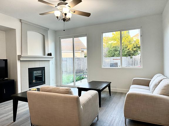 Spacious Living Room with Gas Fireplace and direct access to patio