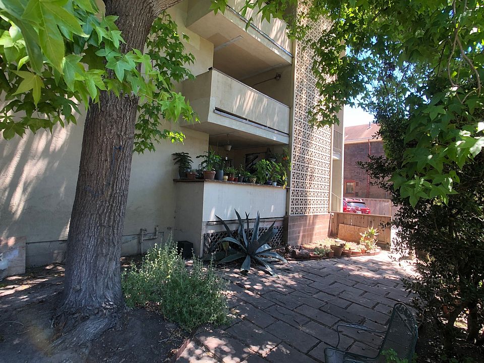 Fenced patio sitting area. exterior pf second floor balcony belonging to #4