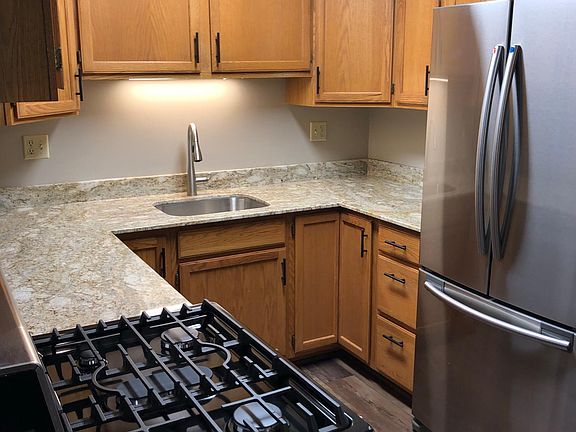 Kitchen with new granite countertops, brand new stainless steel Samsung appliances, new sink, and new Moen faucet.