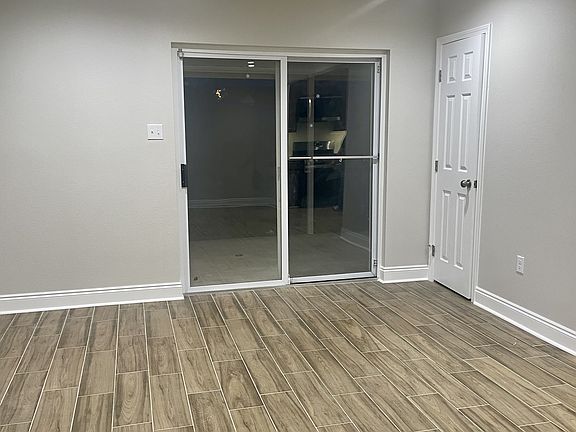 Sliding glass door provides easy access to a private backyard, bringing in natural light and outdoor convenience.