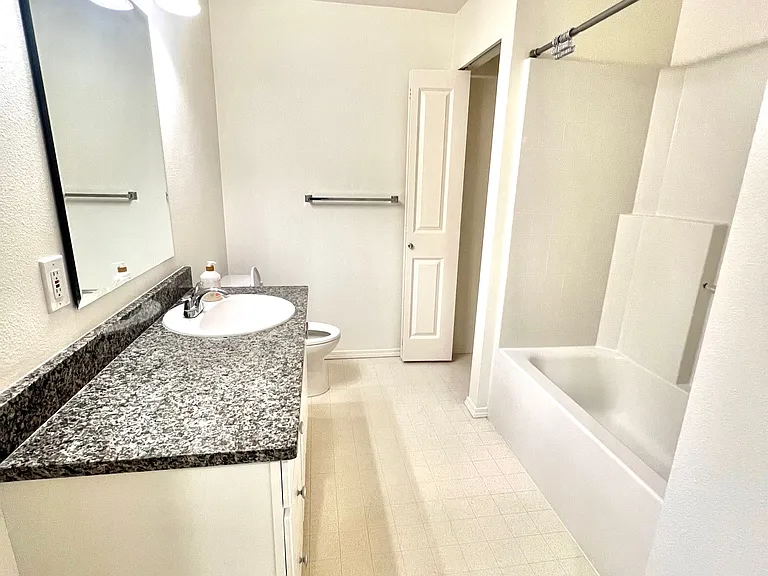 Second bathroom with granite countertops and soaking tub