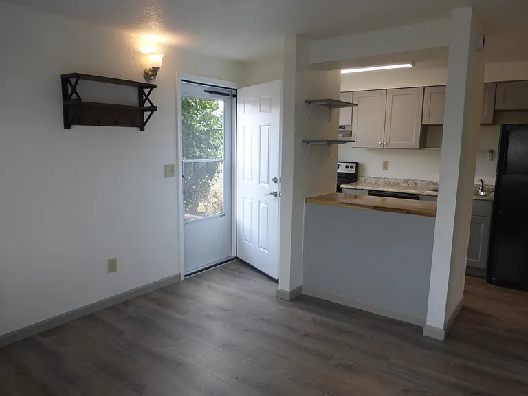 Open concept living room and kitchen with breakfast bar.