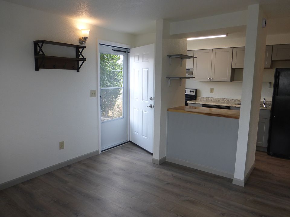 Open concept living room and kitchen with breakfast bar.