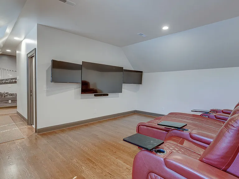 "ESPN" lounge with Triple TV's and Red leather recliners