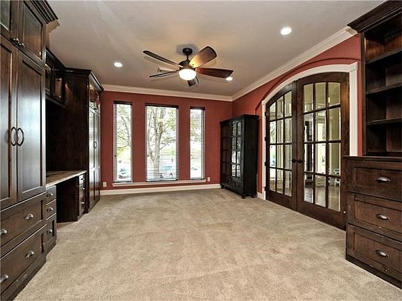 Inside the study are custom built cabinets offering a great office space as well as ample storage.