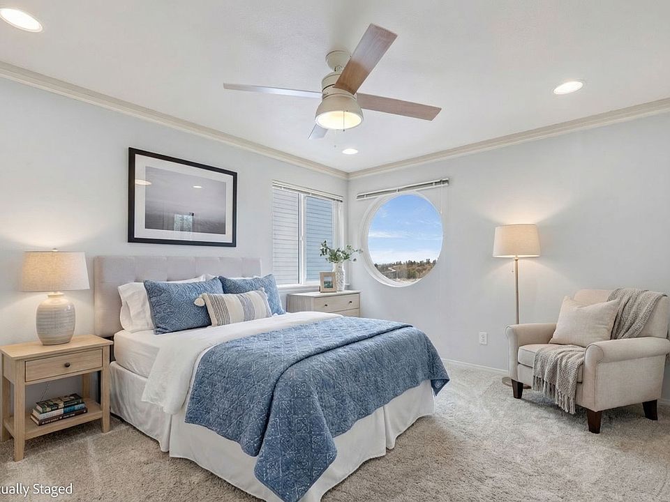 Primary bedroom features great views, updated lighting, a ceiling fan, ensuite bathroom, large walk-in closet and door to the private balcony.l