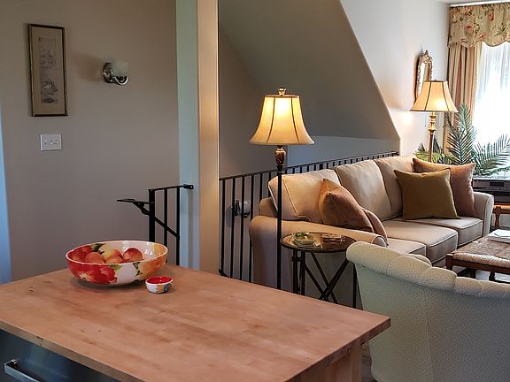 Living Room/Staircase from entry below. Butcher block kitchen island.
