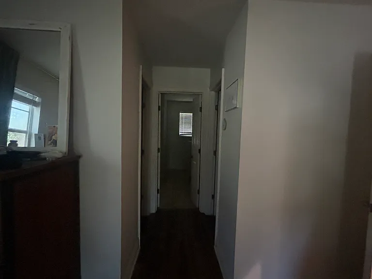 Primary hall to two walk in closets and primary bath