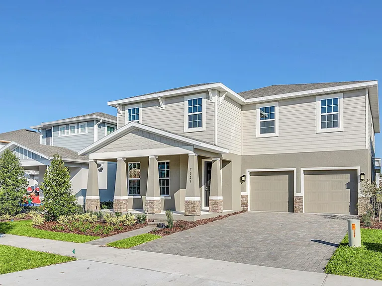 Beautiful Entrance with 2 Car Garage and Paver Brick Driveway