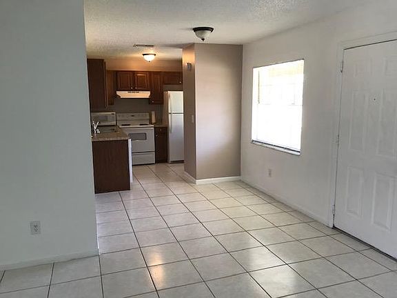 Shot from living room of dining area and kitchen.