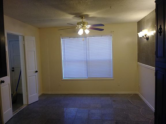 Another view of dining room that shows the matching granite floors to match the granite decorative wall