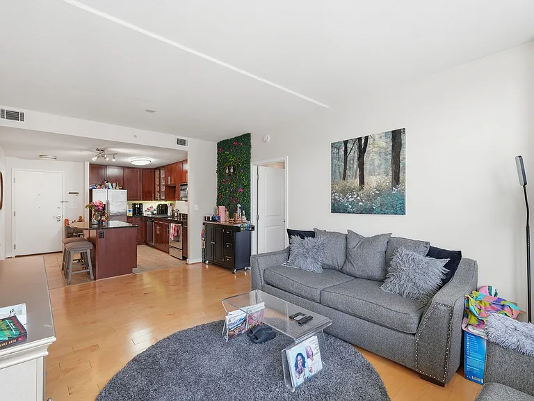 Open living and dining area with hardwood flooring and contemporary finishes