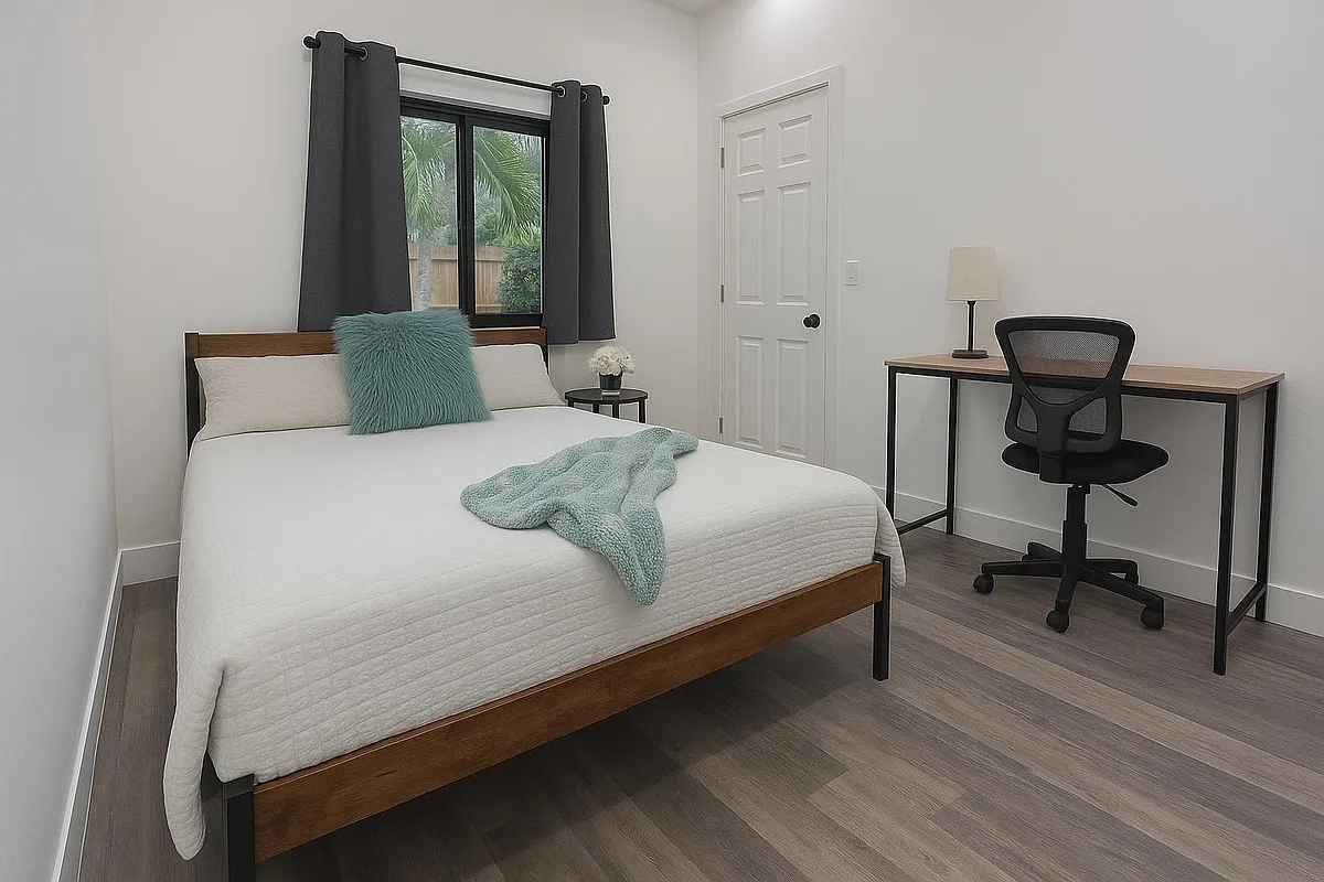 Large room with queen bed and a workspace. - NW 25th Ave