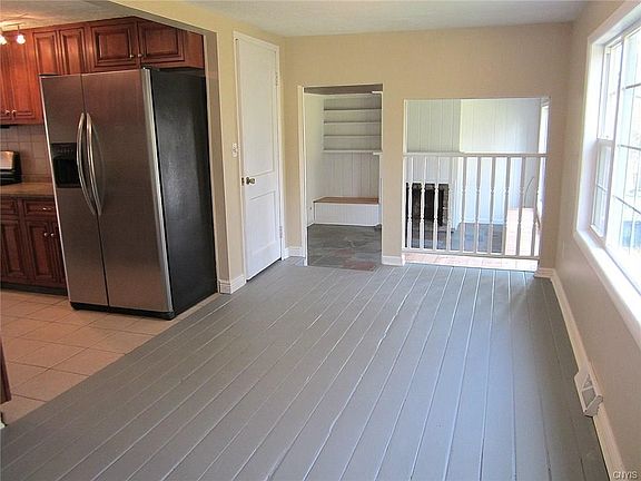 The Dining Area is very spacious, has a freshly painted wood floor, newer windows for lots of natural lighting, and steps down into the Family Room and the Garage door.