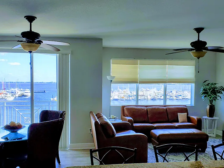 Dining room table with TV room with views of water