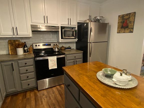 Island provides storage, extra counter space and functional flow in the kitchen
