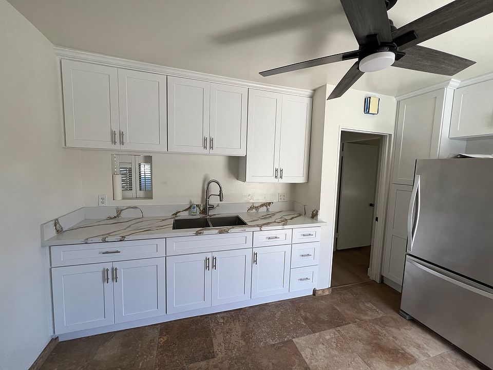 Remodeled Kitchen with brand new cabinets, countertops, sink, refrigerator, gas stove and ceiling fan