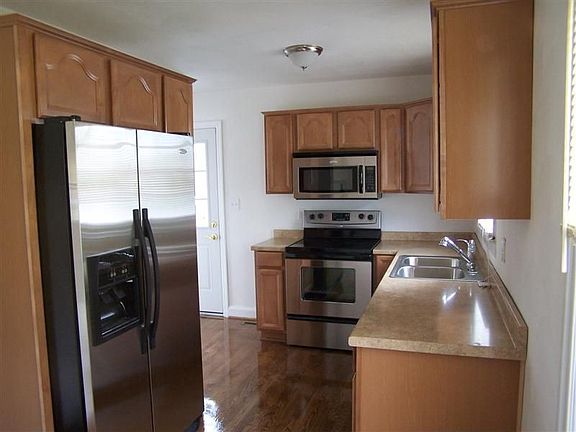 Fully renovated kitchen: stainless appliances, cabinets and floor.