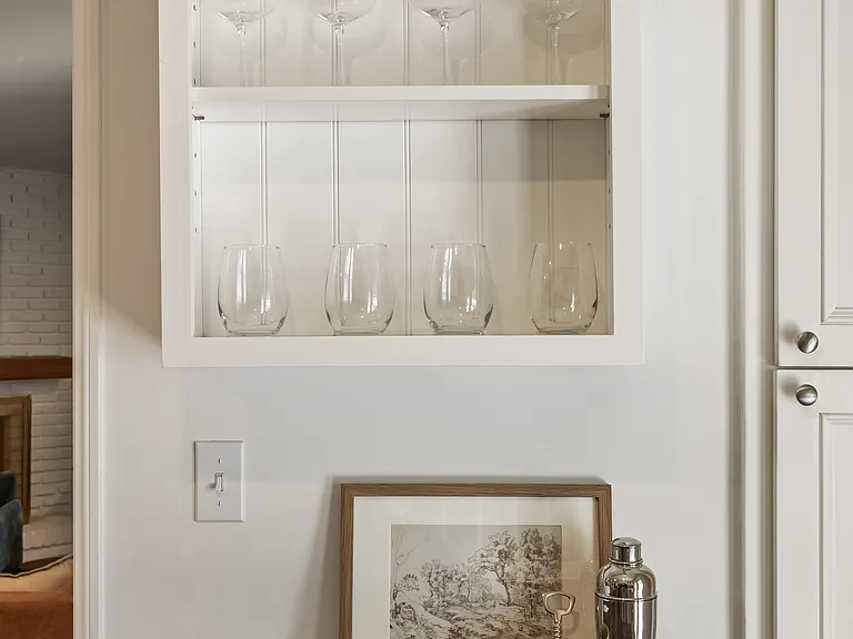 Fully stocked kitchen with abundant natural light, backyard views, bar seating, and a convenient work station for everyday living.