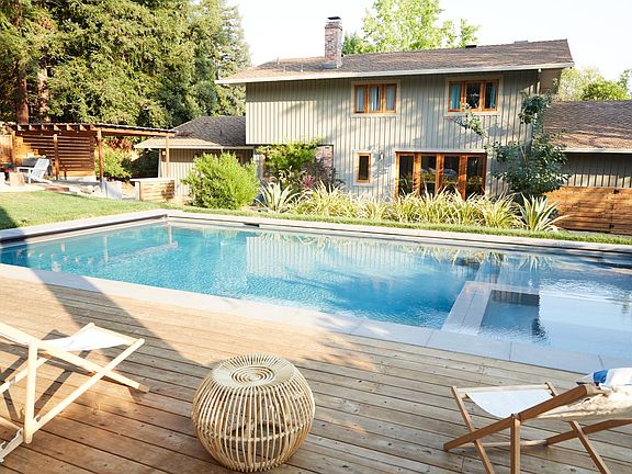 Heated pool and spa with retracting cover