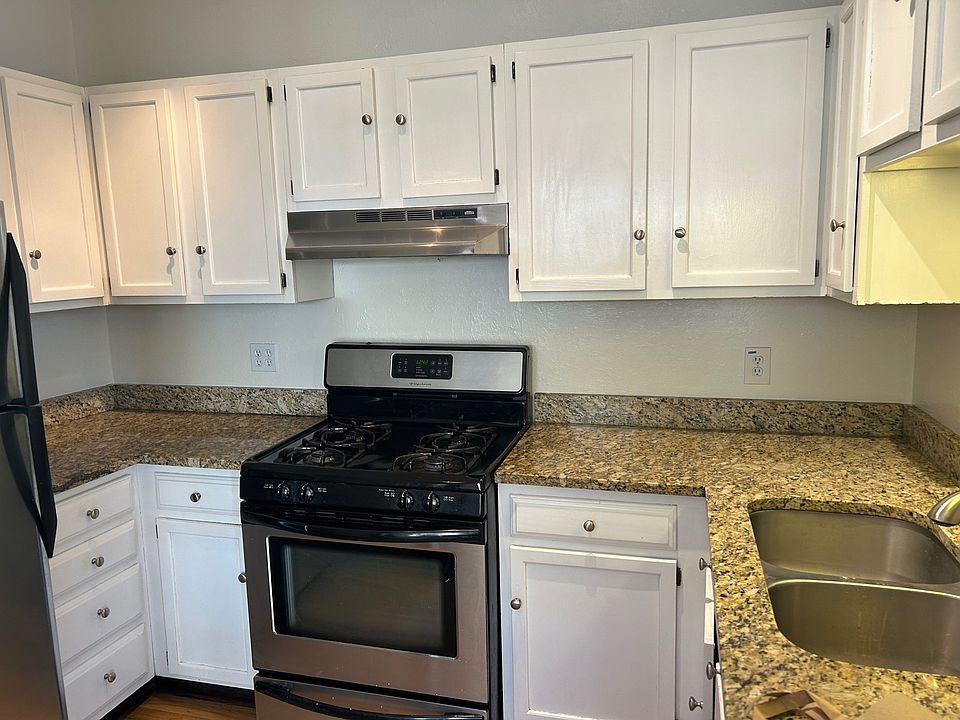 Kitchen with gas stove and marble counter tops.