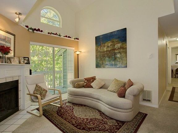 Open floor plan & vaulted ceilings! Palladium window & tile surround fireplace in the living room add to the charm!