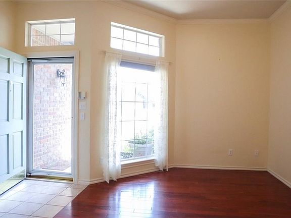 The entry with a storm door is nice for added light. The wood floored room to the right could be anything you want it to be!