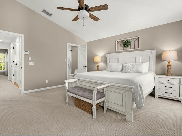 Primary bedroom on third floor with large closet with built-in storage, fully renovated bathroom with frameless shower and LED mirror