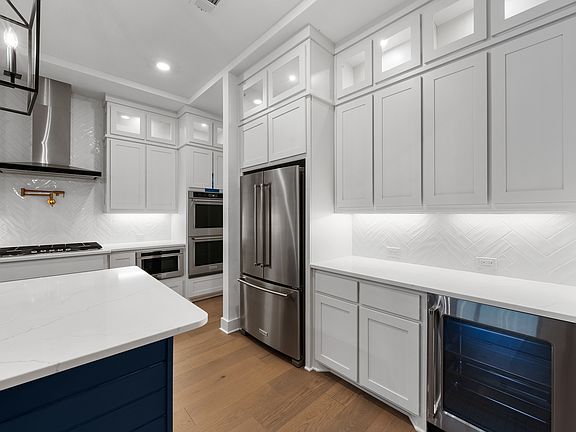 The kitchen has goregous white tile backsplash.