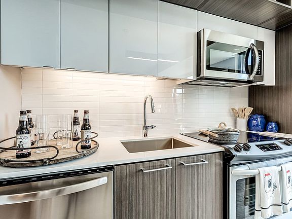 Contemporary kitchens include glass tile backsplash, premium quartz countertops, and designer lighting