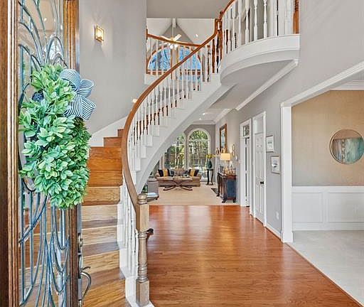 As you enter this home, you are greeted with wood floors and a grand staircase.