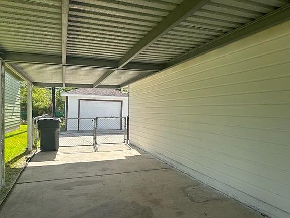 Side of house with driveway leading to detached garage