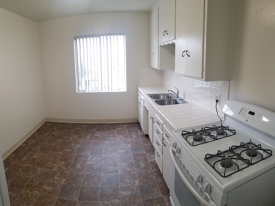 Kitchen. White tile countertop with white appliances.