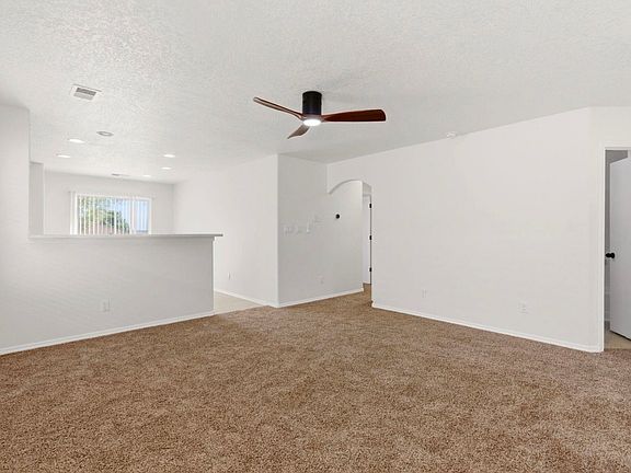 Bright living room leads to kitchen