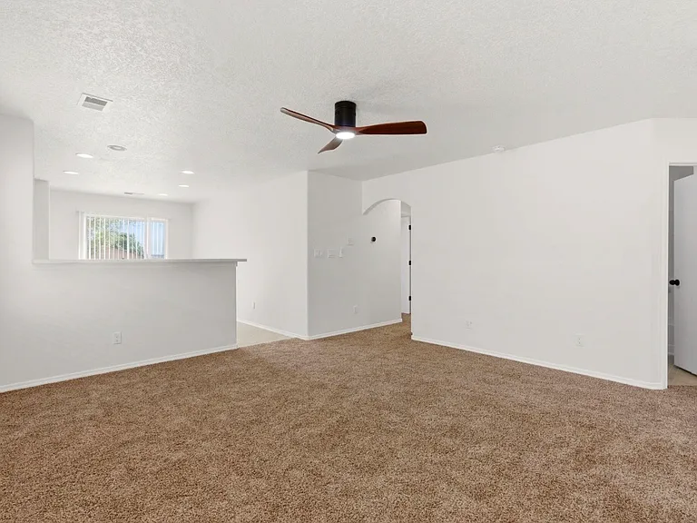 Bright living room leads to kitchen