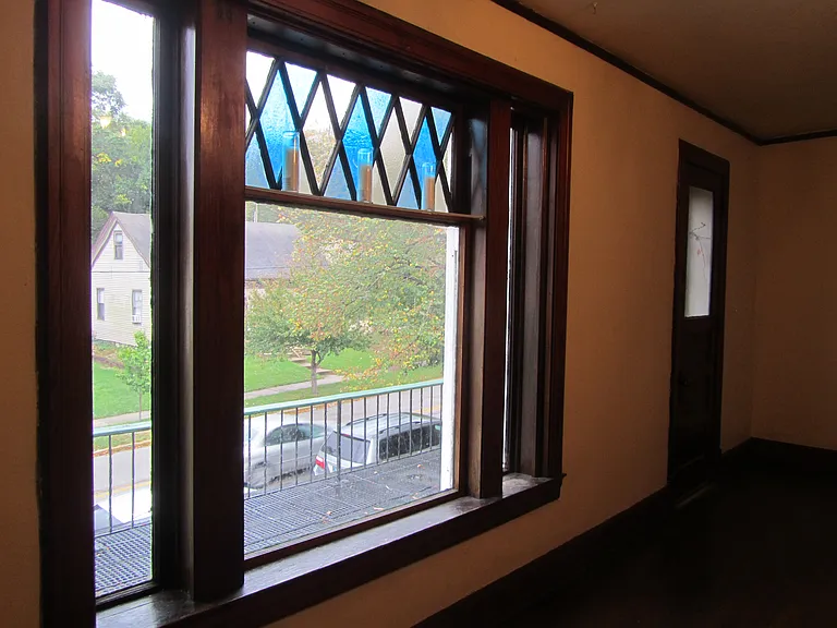 Living room window and door that leads out to balcony
