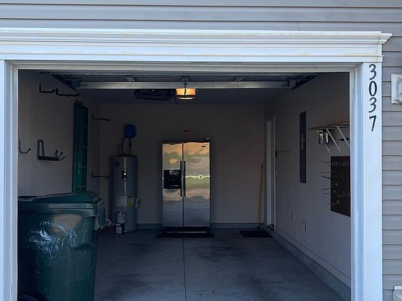 Garage with refrigerator.
