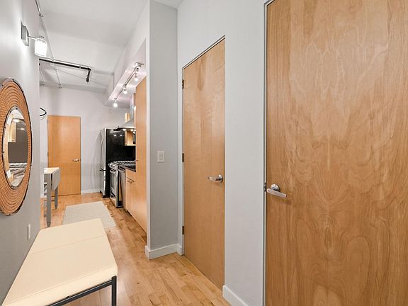 Foyer with half bathroom and closet (with Elfa system installed for maximum storage potential)