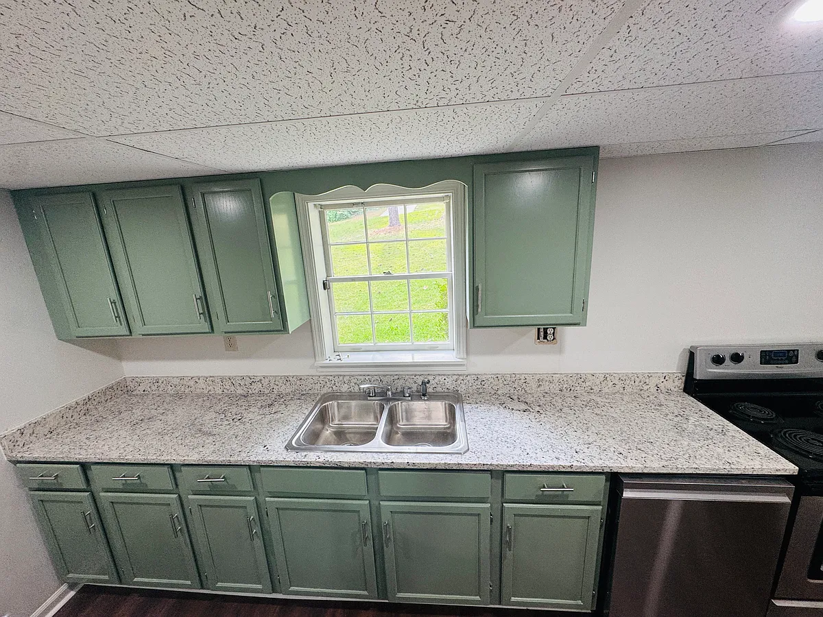 Fully renovated kitchen with newly painted cabinetry, brand-new quartz countertop, stainless steel dish washer, electric cooktop and fridge included - 4875 Millen Dr SE