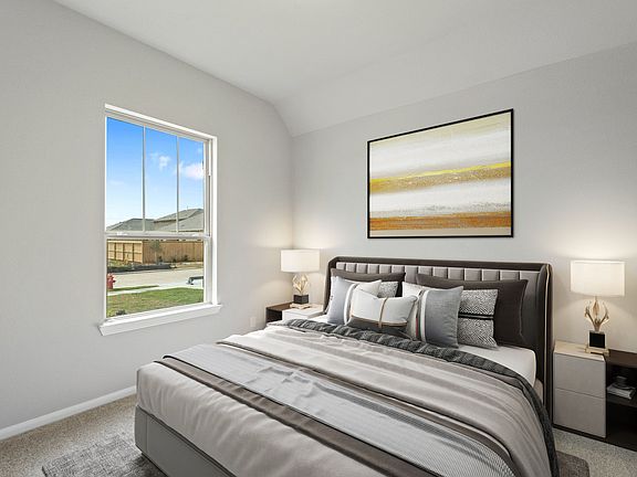 The secondary bedroom features plush carpet, fresh paint, closet, and a large window that lets in pl