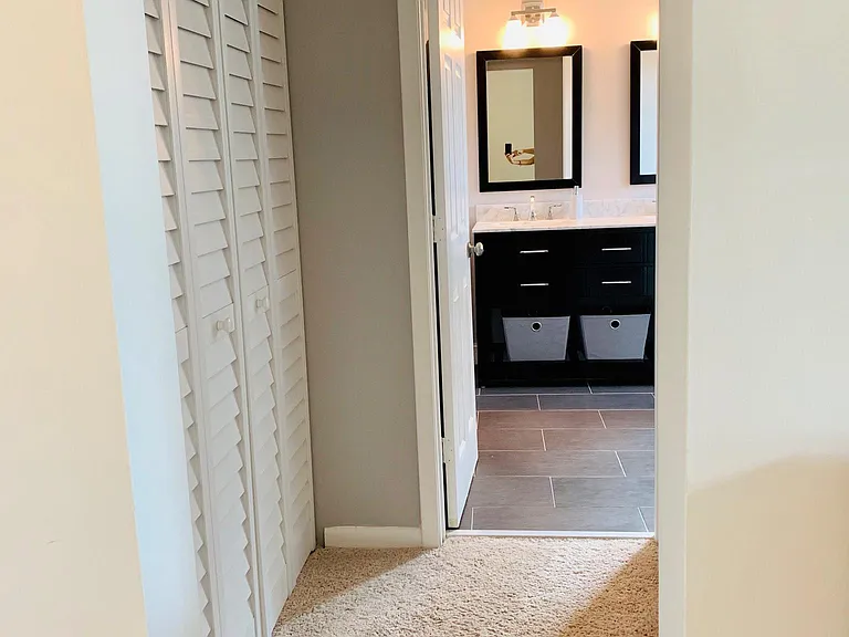 Hall way to master bathroom. On the right is the walkin-in closet on the left is the towel and linen closet.