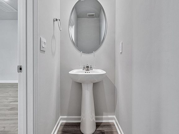 The main floor powder room is off the living room.