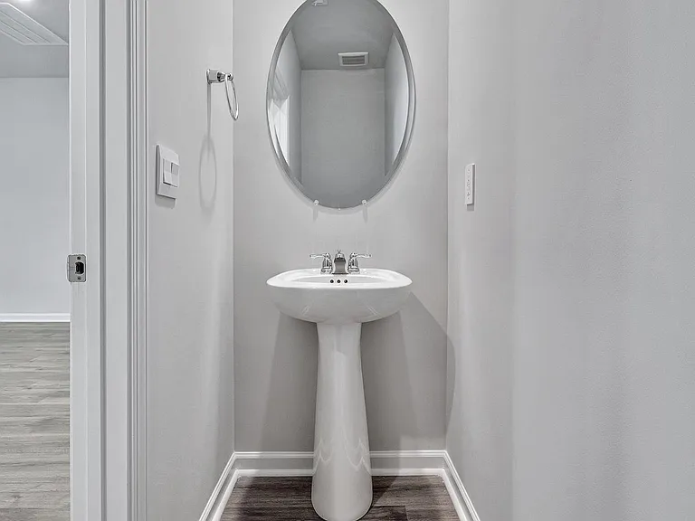 The main floor powder room is off the living room.