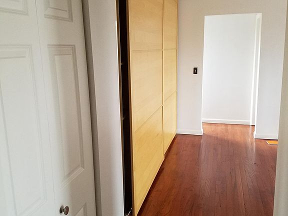 Entryway, sliding door storage cabinet at left