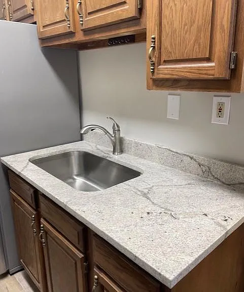 New quartz countertops along with new stainless steel sink and faucet.