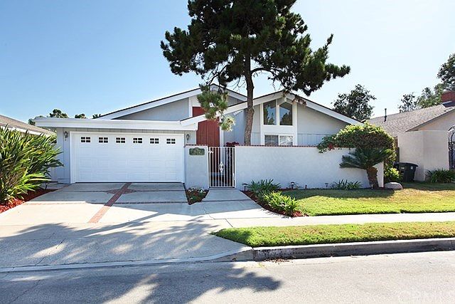 Freshly painted exterior of this expanded "Plan 17" with it's gated courtyard entrance in Tustin Meadows.