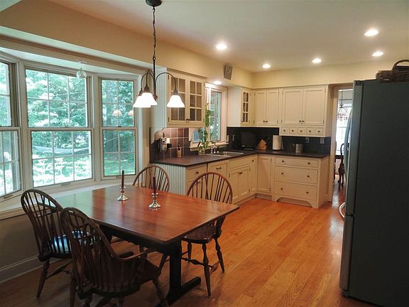 Nice size renovated eat-in kitchen with hardwood floors, and stainless appliances.